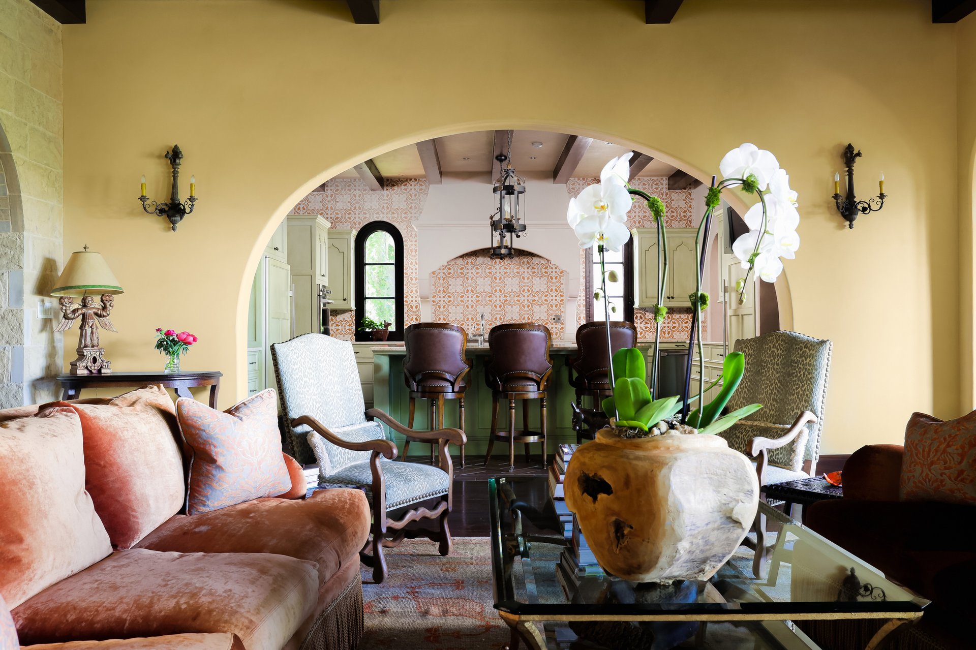 Sitting area framed by an arched opening into the kitchen